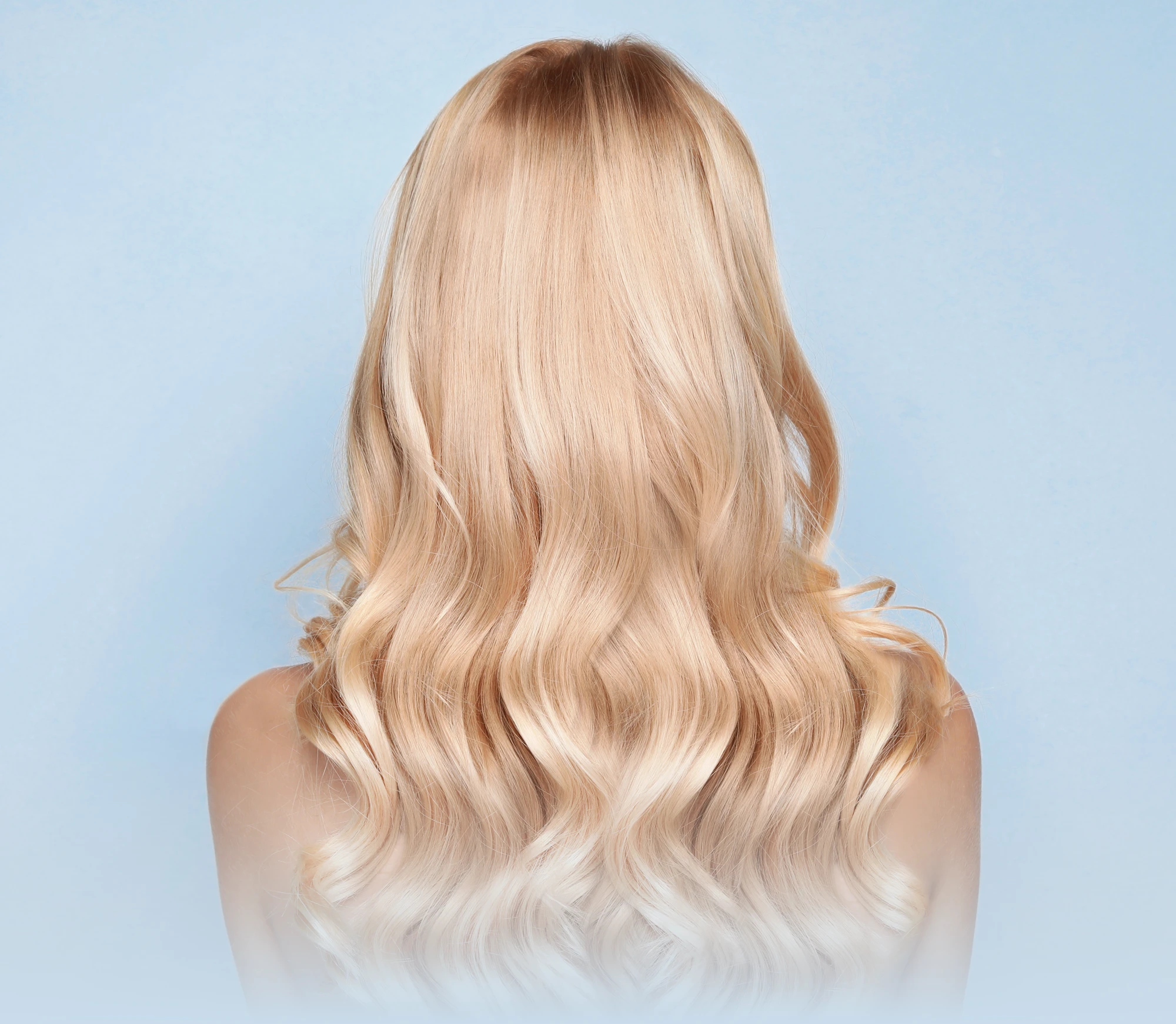 Back view of a woman with long wavy blonde hair on a light blue background